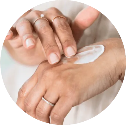 Person applying cream to the back of their hand